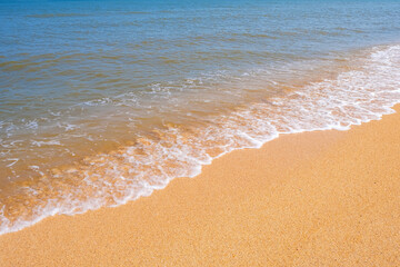 The coast of the Sea of Azov. Sea waves roll on the sandy shore. Seashell sandy beach.