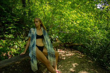 beautiful blonde in a swimsuit walks in the mountains