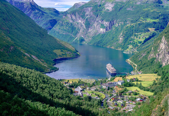 Panoramic view of Geiranger, a small tourist village at the head of the Geirangerfjord, where the Geirangelva river empties. Photo taken from Flydalsjuvet viewpoint.