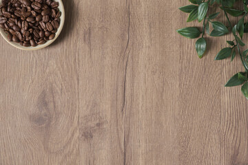 top view, flat lay blank background on wooden desktop with coffee bean and plant on table in a cafe or at home. breakfast beverage morning concept. wood texture