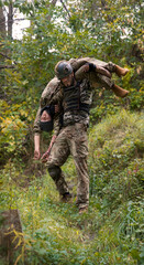 The commander carries a wounded soldier