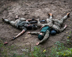 Wounded soldiers lie on the battlefield