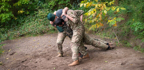 Fototapeta premium The medical workers carries a wounded soldier