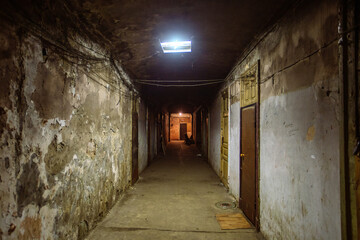 Dark corridor of old shabby dorm or appartment house - obrazy, fototapety, plakaty