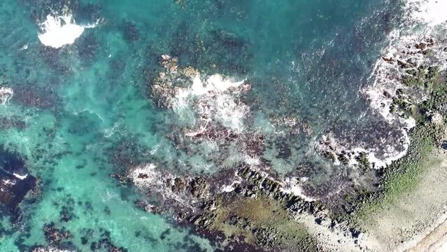 Bird's Eye View Over Caleta Cha&ntilde;aral de Aceituno Waves Splashing On Rock Formations In South Chile - drone shot
