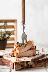 Grilled pork steak sliced with fork on serving board with herbs and spices in rustic style for menu, recipe