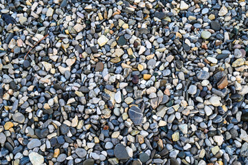 Pebbles on the sea coast. A gravel beach on the shore.