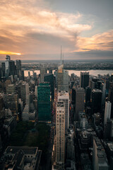 city at sunset in Manhattan New York views skyscraper streets urban buildings river sun sky clouds 