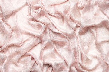 Pink silk fabric background. Copy space, top view