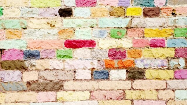 Multicolored brick wall. Texture of vivid wall of bricks. Close up. Concept of background for your text.