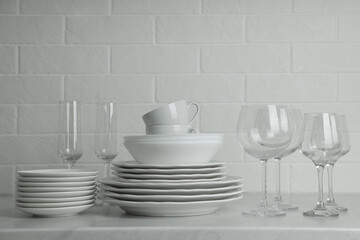 Different clean dishware, cups and glasses on countertop