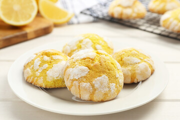 Tasty homemade lemon cookies on white wooden table