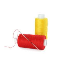 Different colorful sewing threads and needle on white background