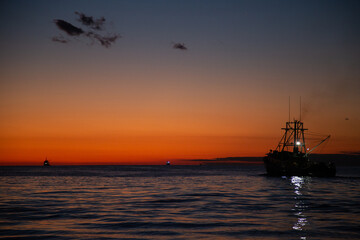 Fototapeta na wymiar Panorama overlooking the sea at sunset. Adriatic Sea and work on a fishing boat.
