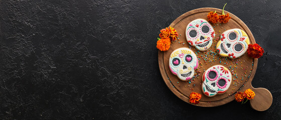 Wooden board with tasty cookies in shape of skull for Mexico's Day of the Dead (El Dia de Muertos)...