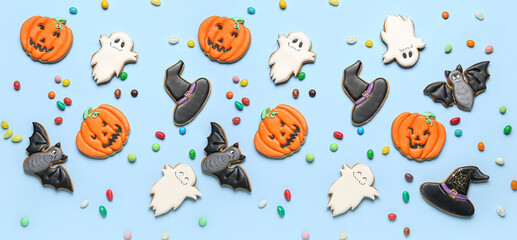 Naklejka premium Many tasty Halloween cookies and candies on light blue background, top view