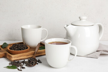 Composition with hot black tea on white table