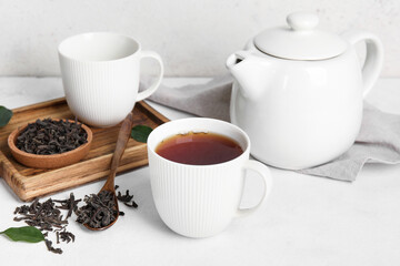 Fototapeta na wymiar Composition with hot black tea on white table