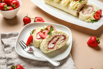 Plate with slices of tasty strawberry roll cake on color background