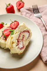 Plate with slices of tasty strawberry roll cake on table, closeup