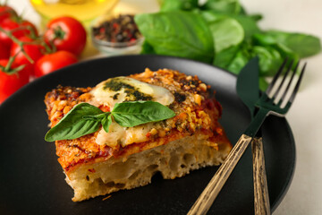 Plate of tasty Italian pie with mozzarella and pesto sauce, closeup