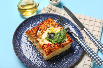 Plate with piece of tasty Italian pie on color background, closeup