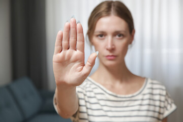 Serious worried young woman making hand stop gesture expressing fighting for equal rights against domestic violence, abuse, discrimination, bullying, sexual or racial discrimination.