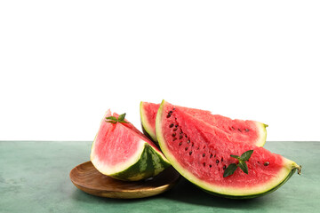 Plate with slices of ripe watermelon and mint on green table against white background