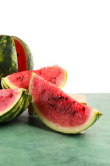 Slices of ripe watermelon on green table against white background