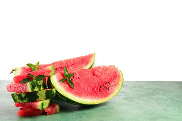 Slices of ripe watermelon with mint on green table against white background