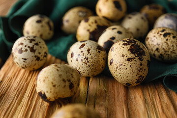 Fresh quail eggs on wooden background, closeup