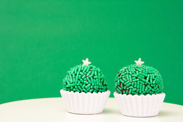 Two Green Brigadeiros, birthday party candy, green background