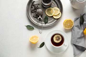 Obraz na płótnie Canvas Cup of black tea with lemon on white background