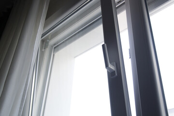 Tilt and turn pvc window leaned in at the top to allow controlled ventilation in the apartment, close up