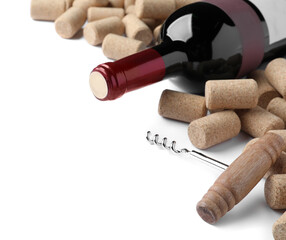 Corkscrew with wine bottle and stoppers on white background