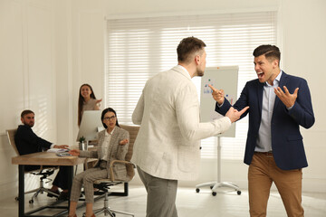 Emotional colleagues fighting in office. Workplace conflict