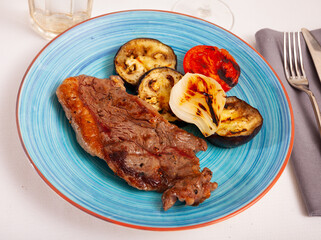 Delicious beef entrecote with baked vegetables closeup