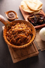 Tinga de Res. Typical Mexican dish prepared mainly with shredded beef, onion and dried chilies. It is customary to serve it on corn tortilla tostadas or tacos.