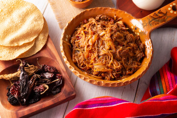Tinga de Res. Typical Mexican dish prepared mainly with shredded beef, onion and dried chilies. It...