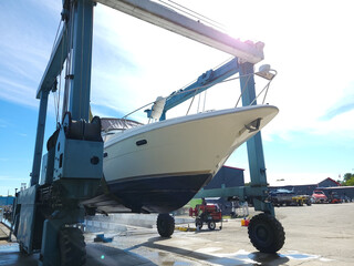 Luxury motor yacht lifted out of the water by a special crane get ready for winter