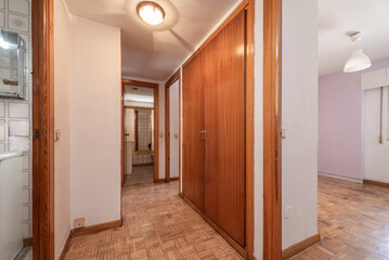 Hallway of an empty urban dwelling with oak parquet flooring
