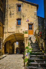 Fototapeta na wymiar Narrow paved street and old houses in the medieval village of Saint Montan in the south of France (Ardeche)