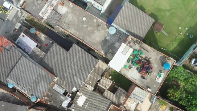 Drone flying above the several residence of Favella and capturing the entire region and roads and many cars parked at roads