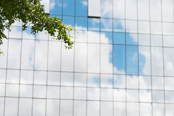 Clouds reflected in modern office building wall