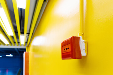 Fire alarm on the yellow wall