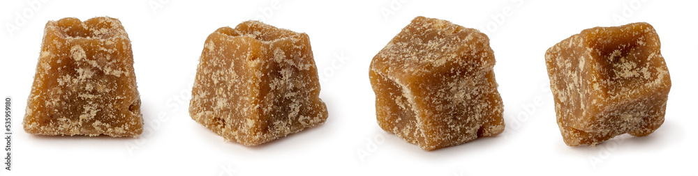 Wall mural close-up macro view of jaggery pieces, golden brown colored cube shaped unrefined sugar product also called kithul jaggery or palm sugar, sweet and sugary traditional food in southeast asia isolated