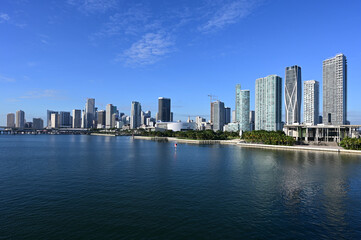 City of Miami, Florida reflected in calm water of Biscayne Bay on sunny autumn morning.
