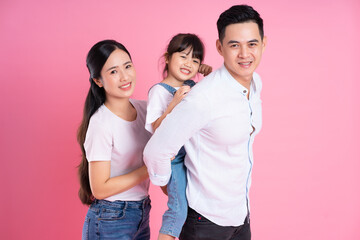 Fototapeta premium young asian family image isolated on pink background
