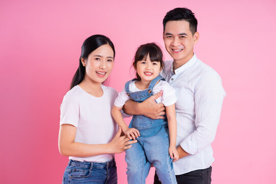 young asian family image isolated on pink background