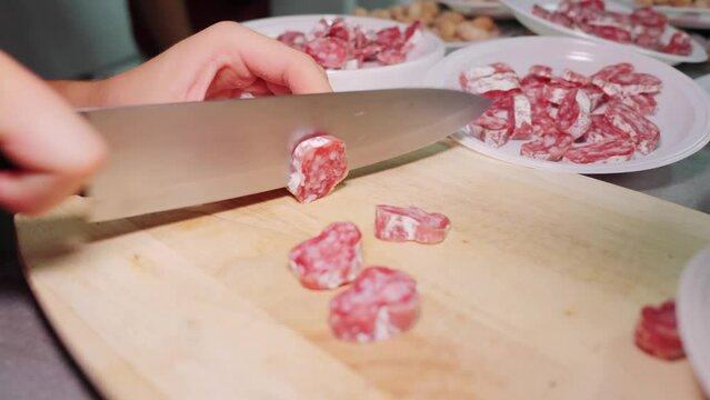 Cutting Spanish fuet on a chopping board.